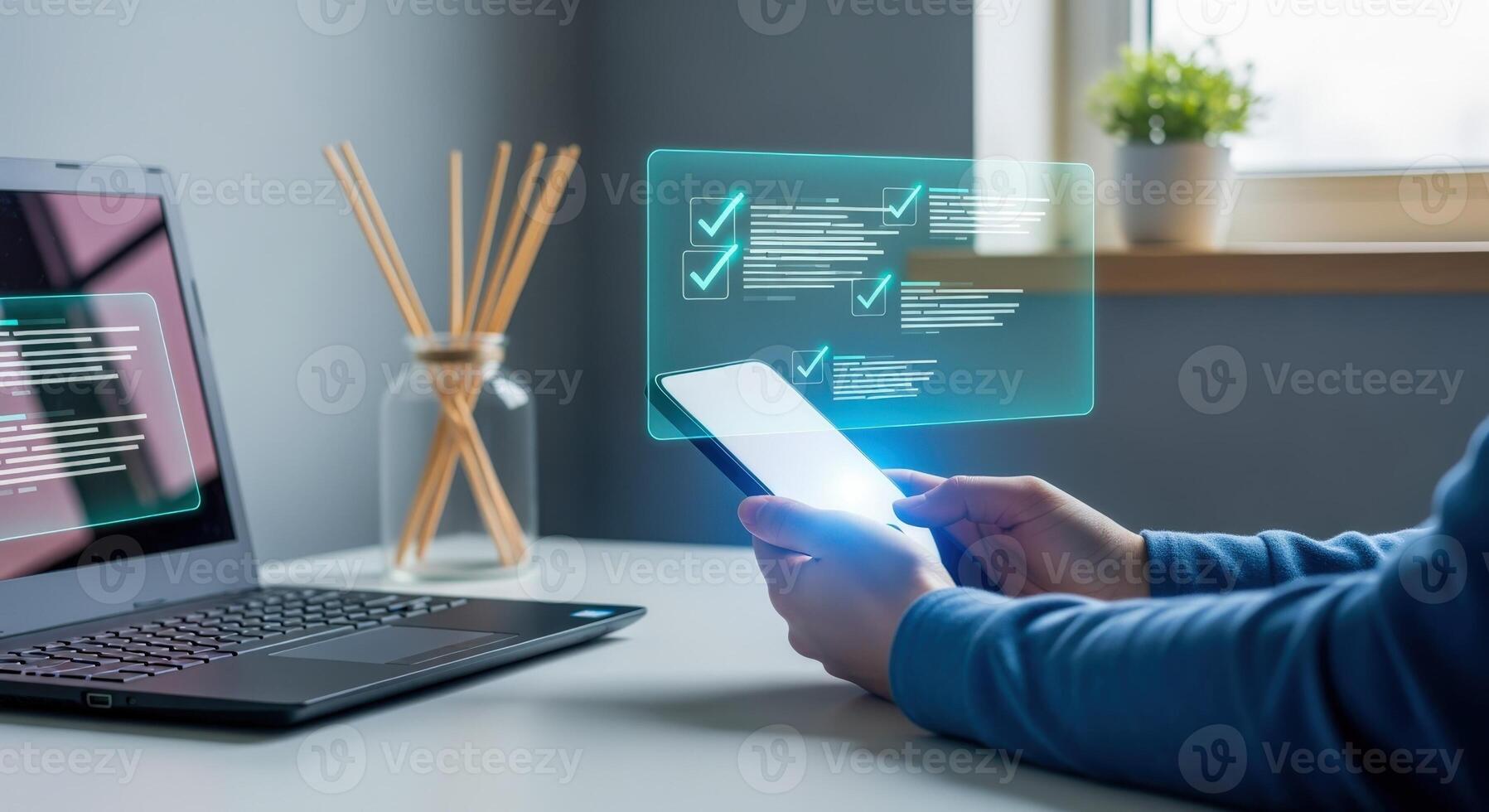 Hands Holding Smartphone Displaying Digital Checklist Overlay with Laptop and Reed Diffuser on Desk photo