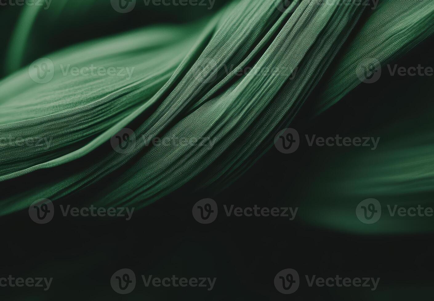 Swirling green fabric showcasing texture and movement in soft lighting photo