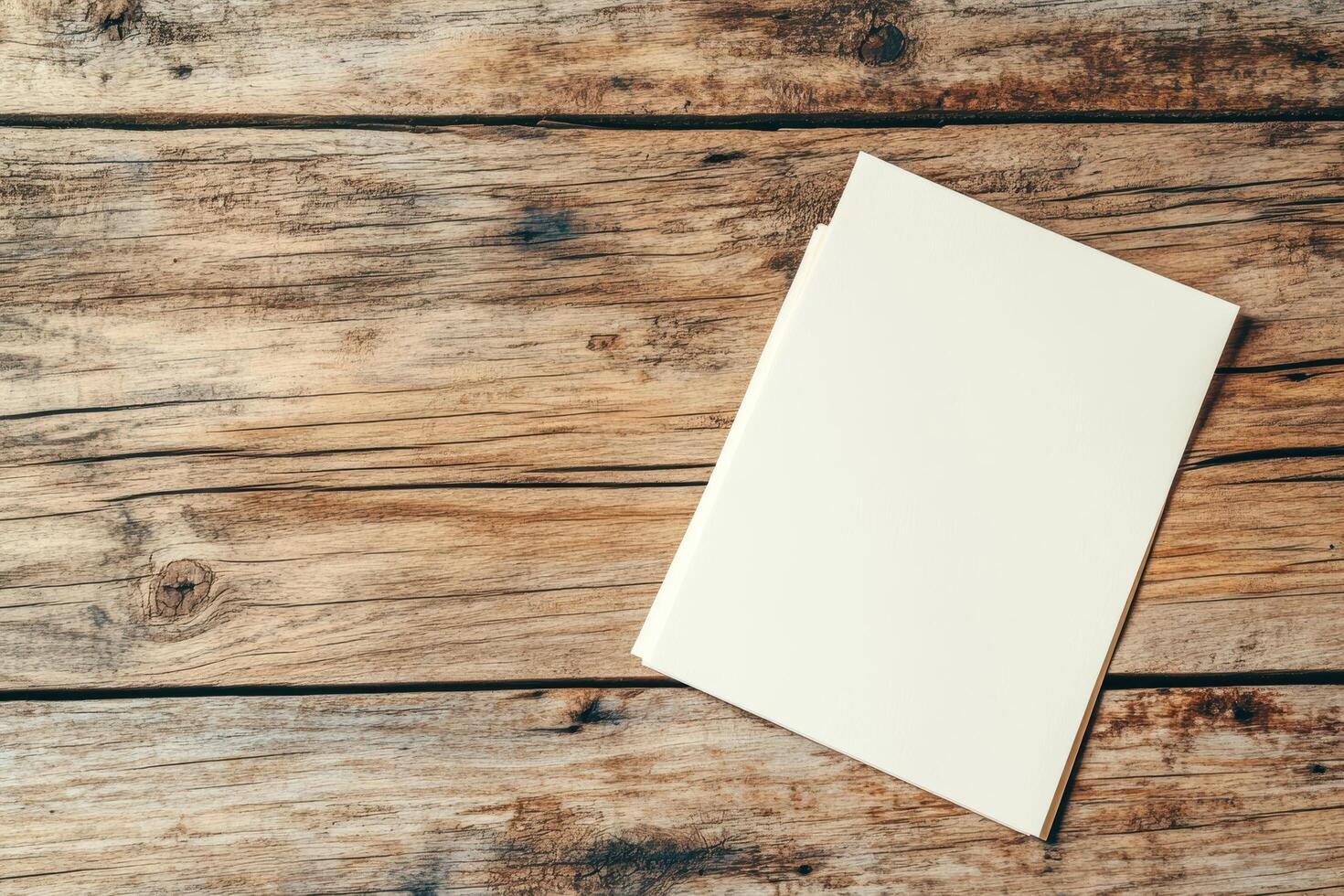 Blank notebook placed on rustic wooden table surface for creative writing photo