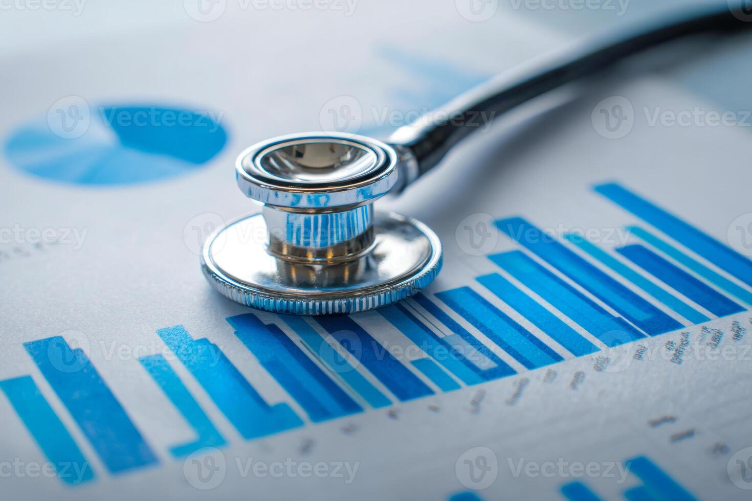 Close-up of a stethoscope resting on medical charts with blue bar graphs and data visualizations symbolizing healthcare analytics and diagnostics photo
