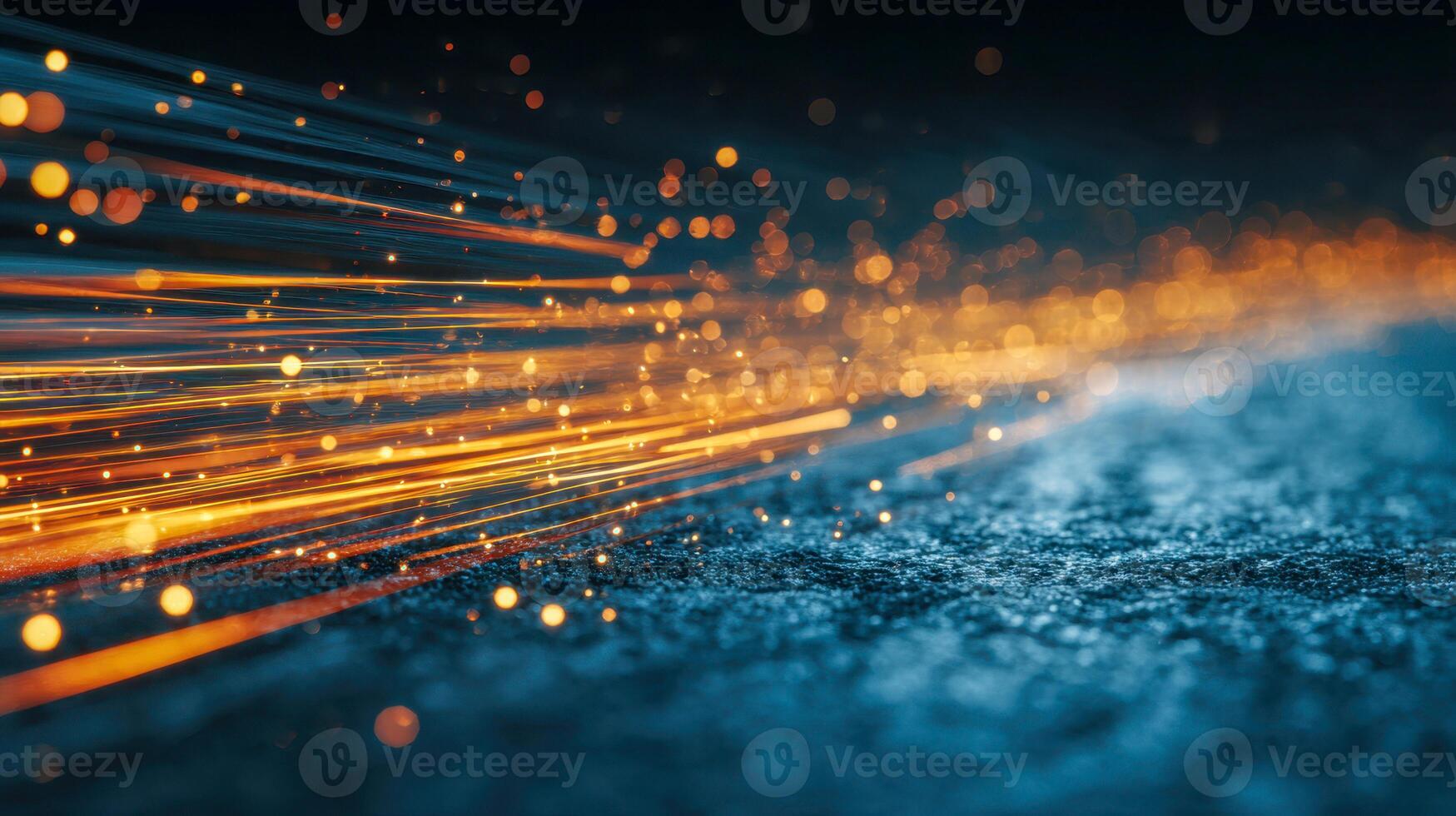 Dynamic stream of glowing orange particles and light trails flowing over a textured dark surface creating a vibrant futuristic visual effect with depth of field blur photo