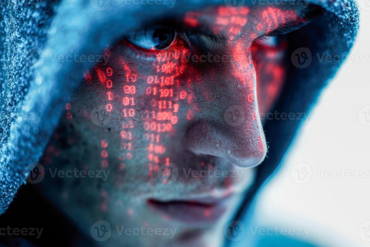 Close-up of a mysterious figure wearing a hood with red illuminated digital code reflections on their face symbolizing cyber security and hacking themes photo