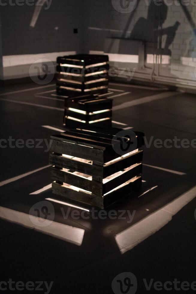 Illuminated Wooden Crates. A Captivating Display of Light and Shadow in a Modern Art Installation. photo