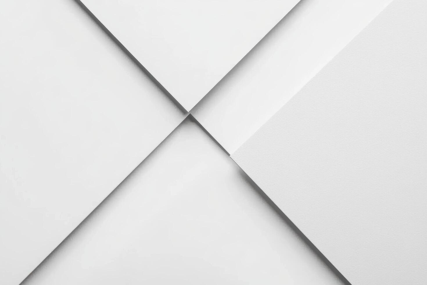 White paper sheets neatly arranged in a cross pattern on a clean surface photo
