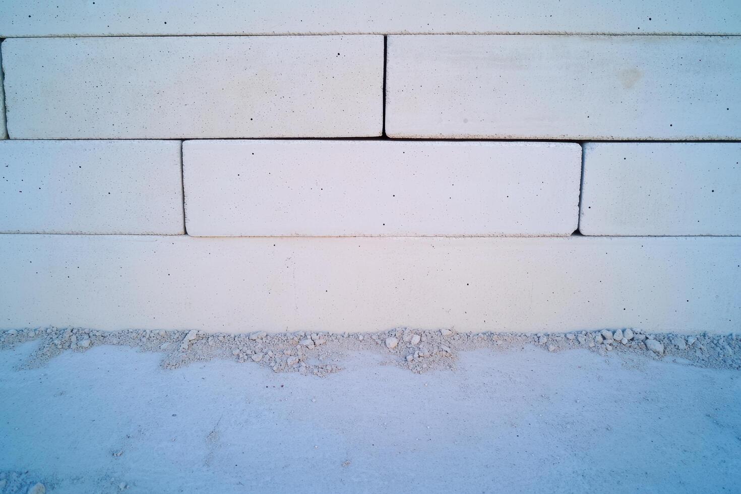 Construction of a solid wall using large concrete blocks in a dry environment photo