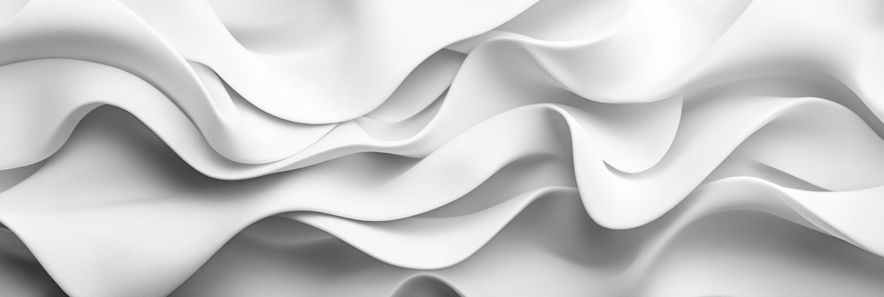 Soft white fabric draped in elegant waves and folds creating an abstract texture photo