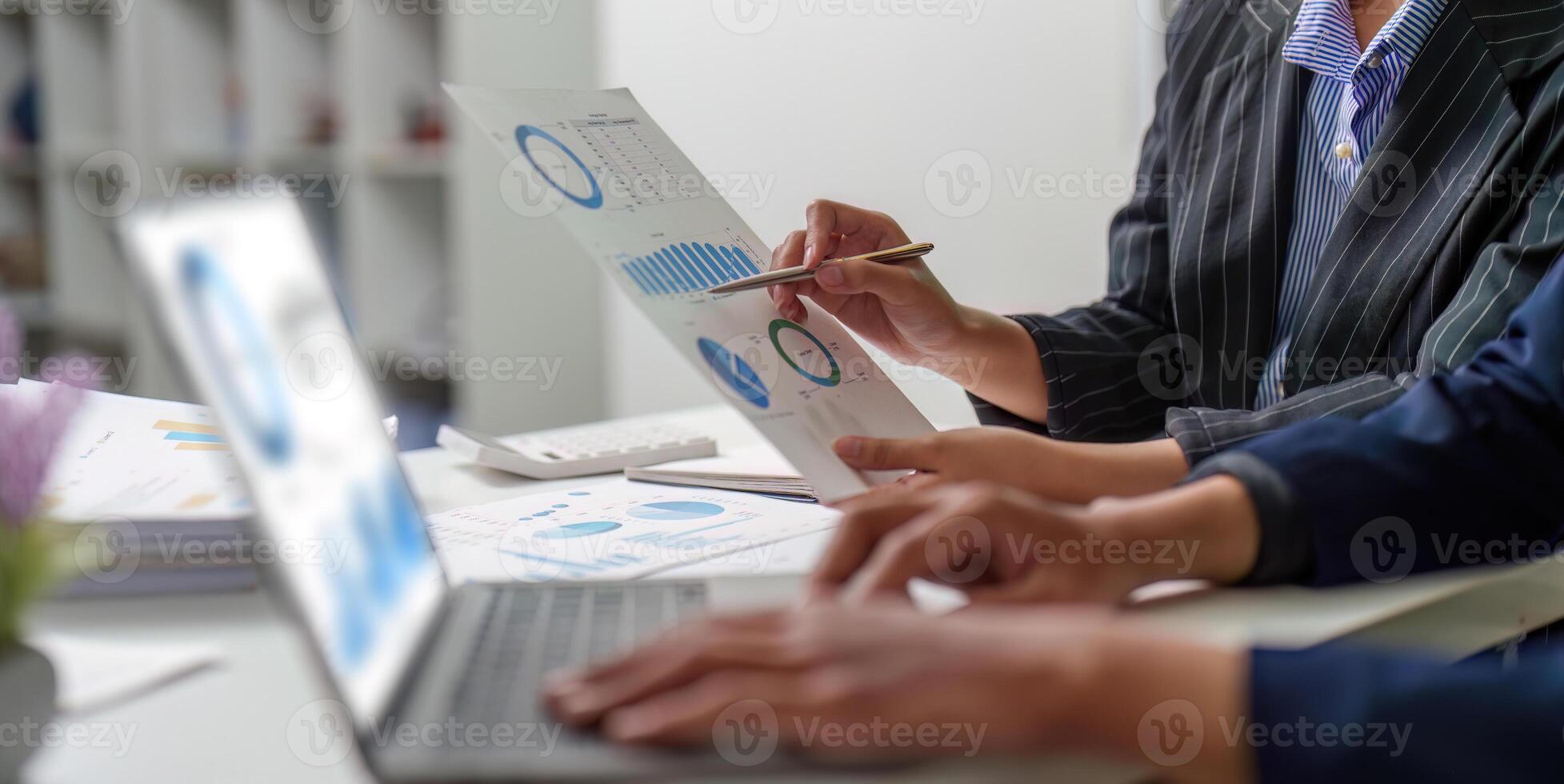 Data Visualization. Business team analyzing financial reports with charts and graphs. photo