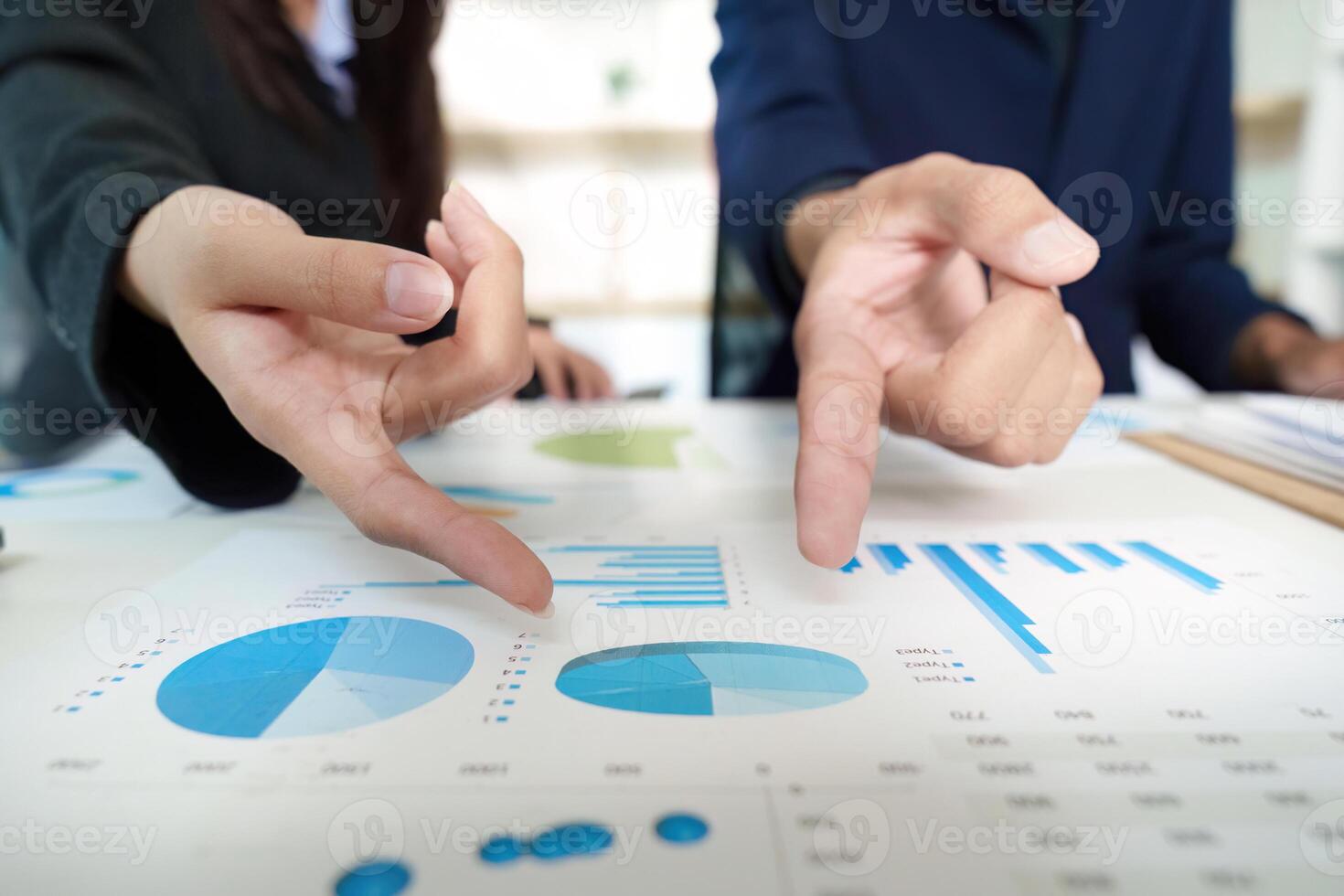 Business Analysis. Team members discussing financial data with charts and graphs. photo