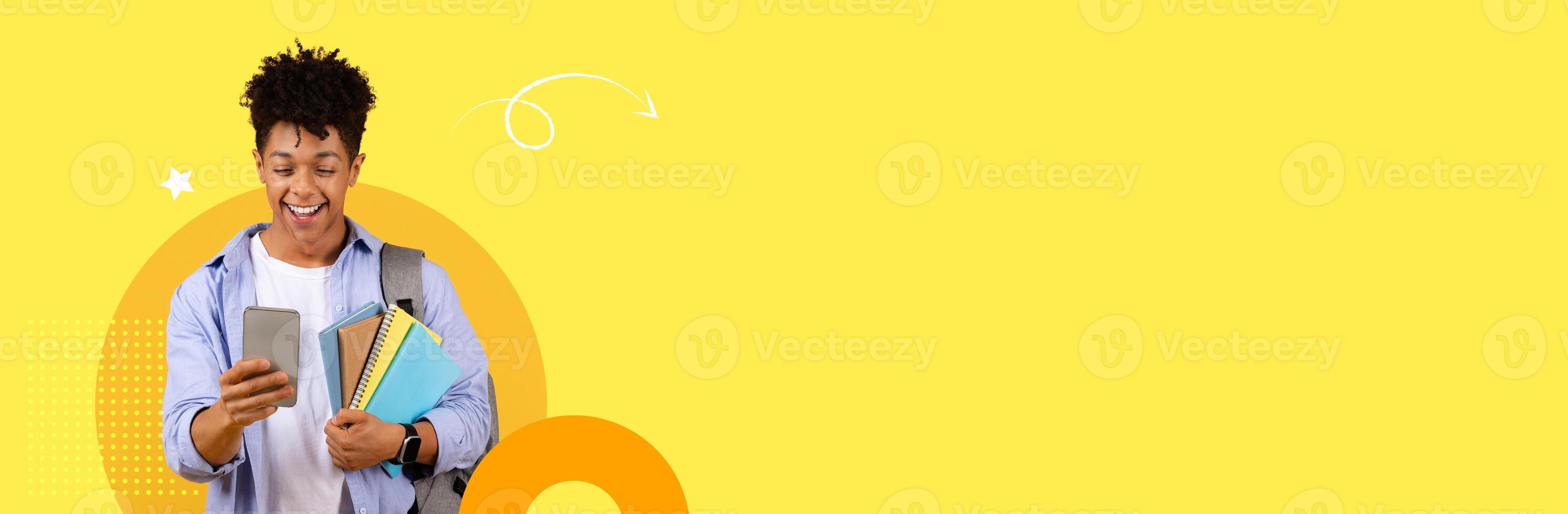 A student is smiling while checking their smartphone, holding notebooks and a folder. They are in a vibrant, modern educational environment, highlighting a joyful learning experience. photo