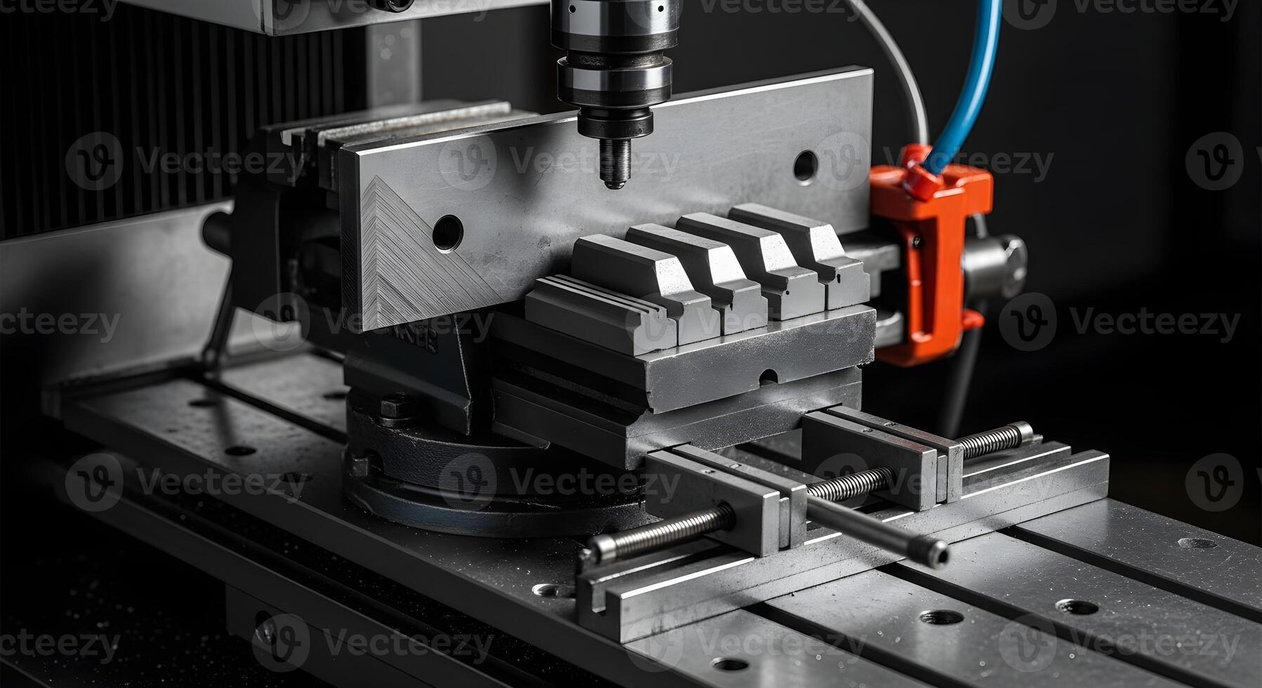 Angle plate with clamps and step blocks in a vise station, captured with natural lighting to emphasize sharp textures . photo