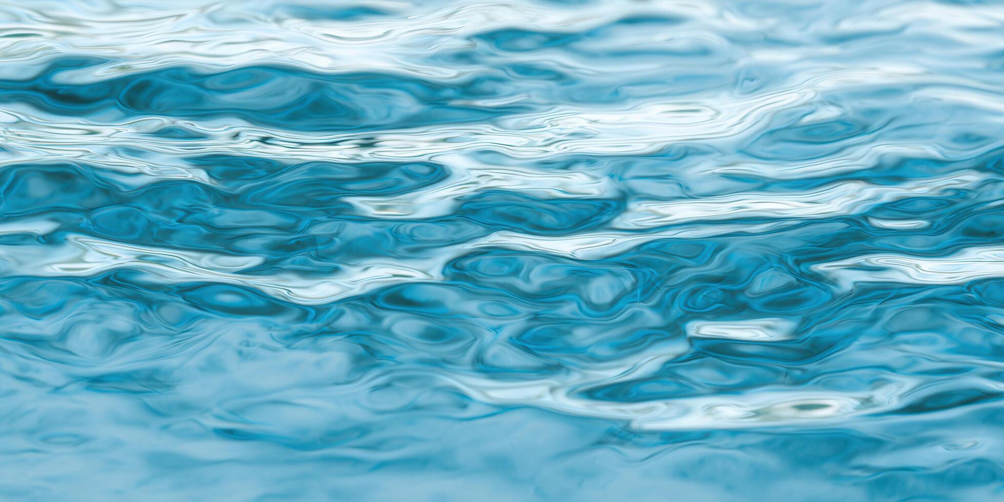 The image showcases an abstract pattern of water's surface with beautiful shades of blue and mesmerizing reflections. photo