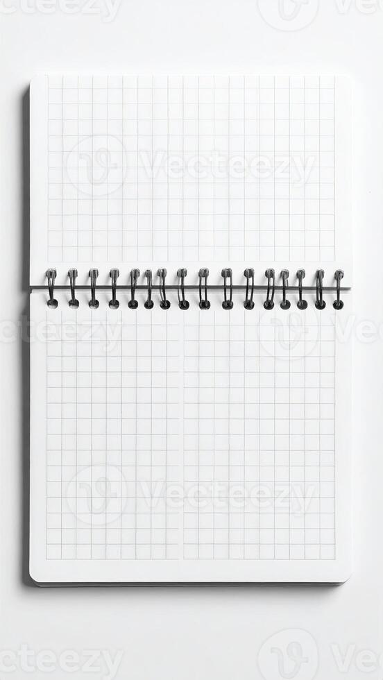 Open spiral-bound notebook with grid paper photo