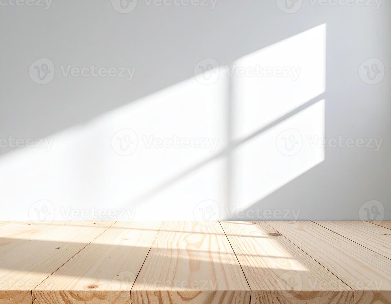 Sunlight streams through a window, casting shadows on a light-colored wooden surface against a plain wall photo