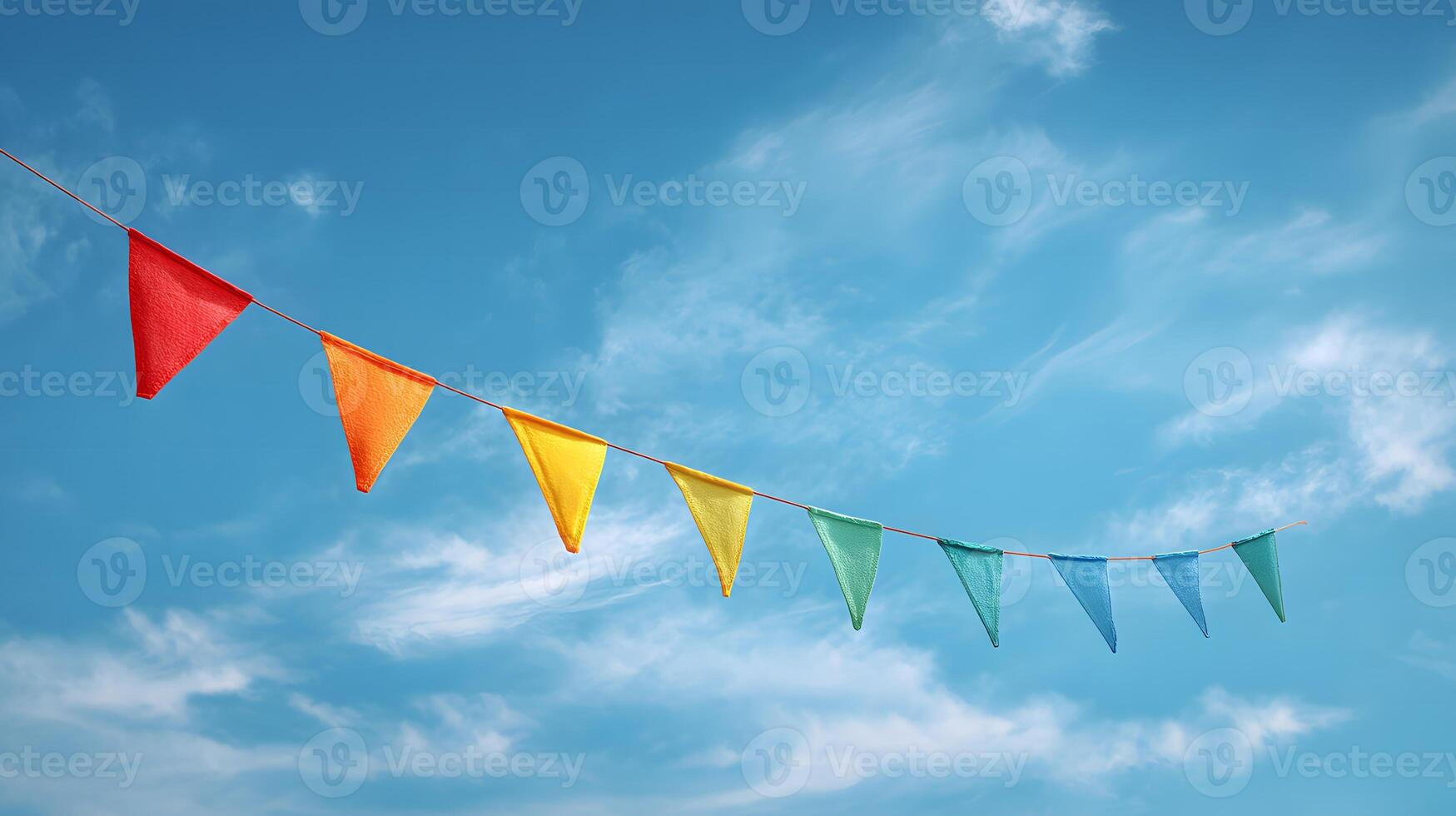 Diagonal string of multicolored bunting flags against a blue sky with wispy clouds. photo