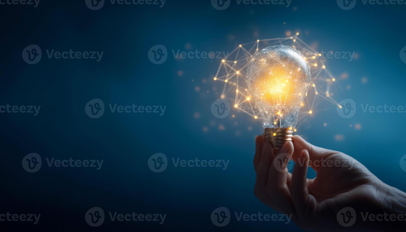Hand holding illuminated lightbulb with digital network connection elements around it photo
