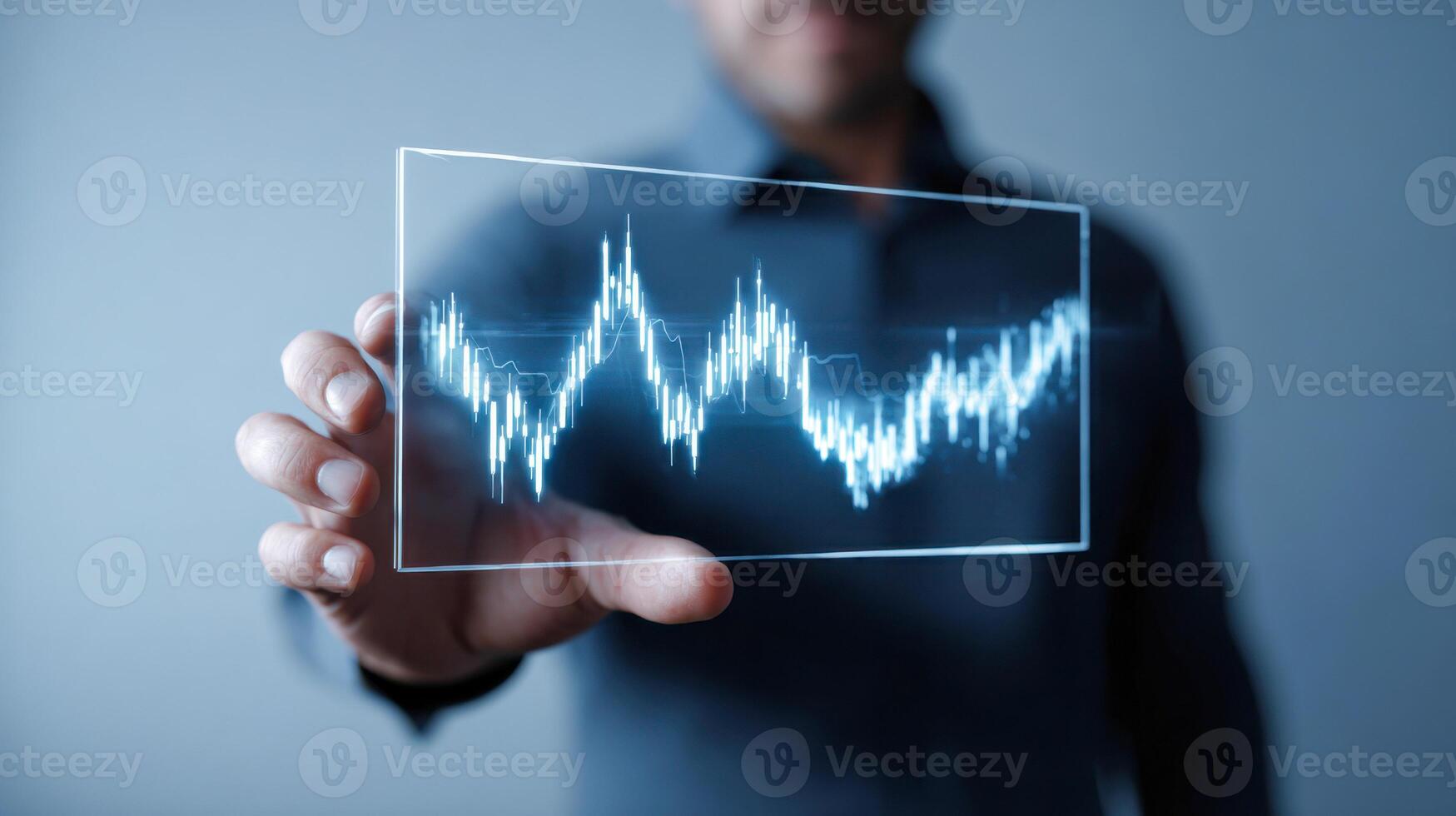 Man holds transparent screen displaying digital financial data and analytics trends photo