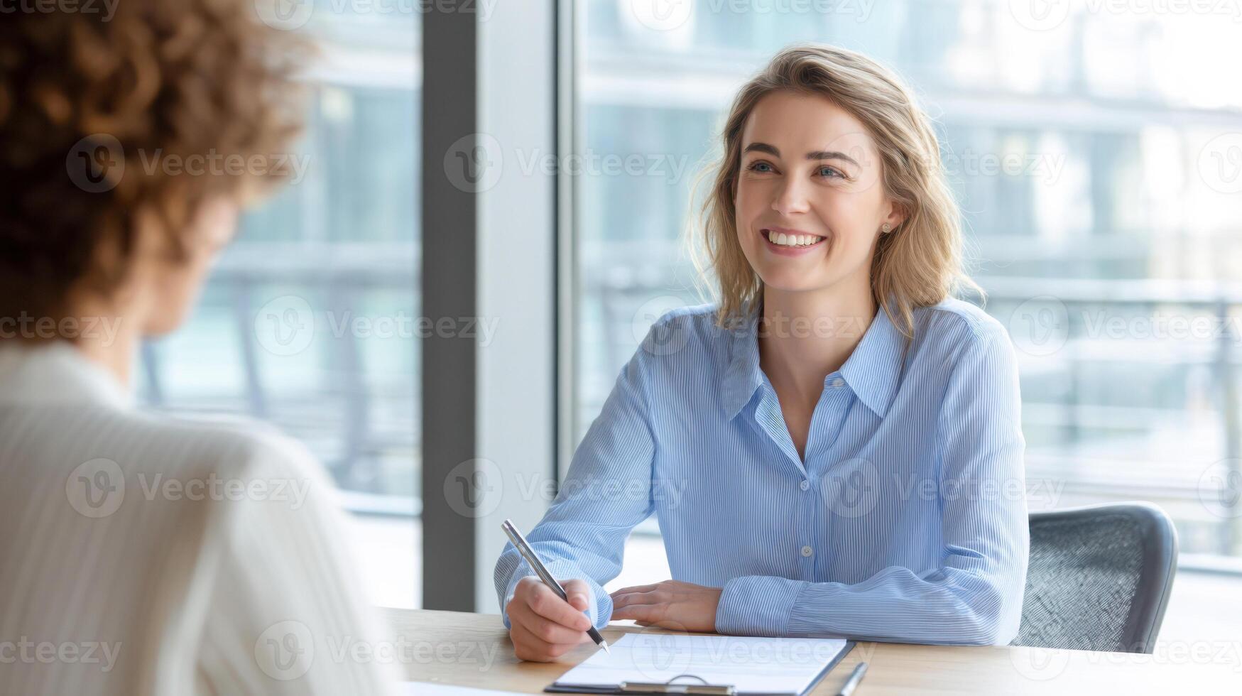 Smiling HR interviewer engages in a friendly conversation during a recruitment interview photo