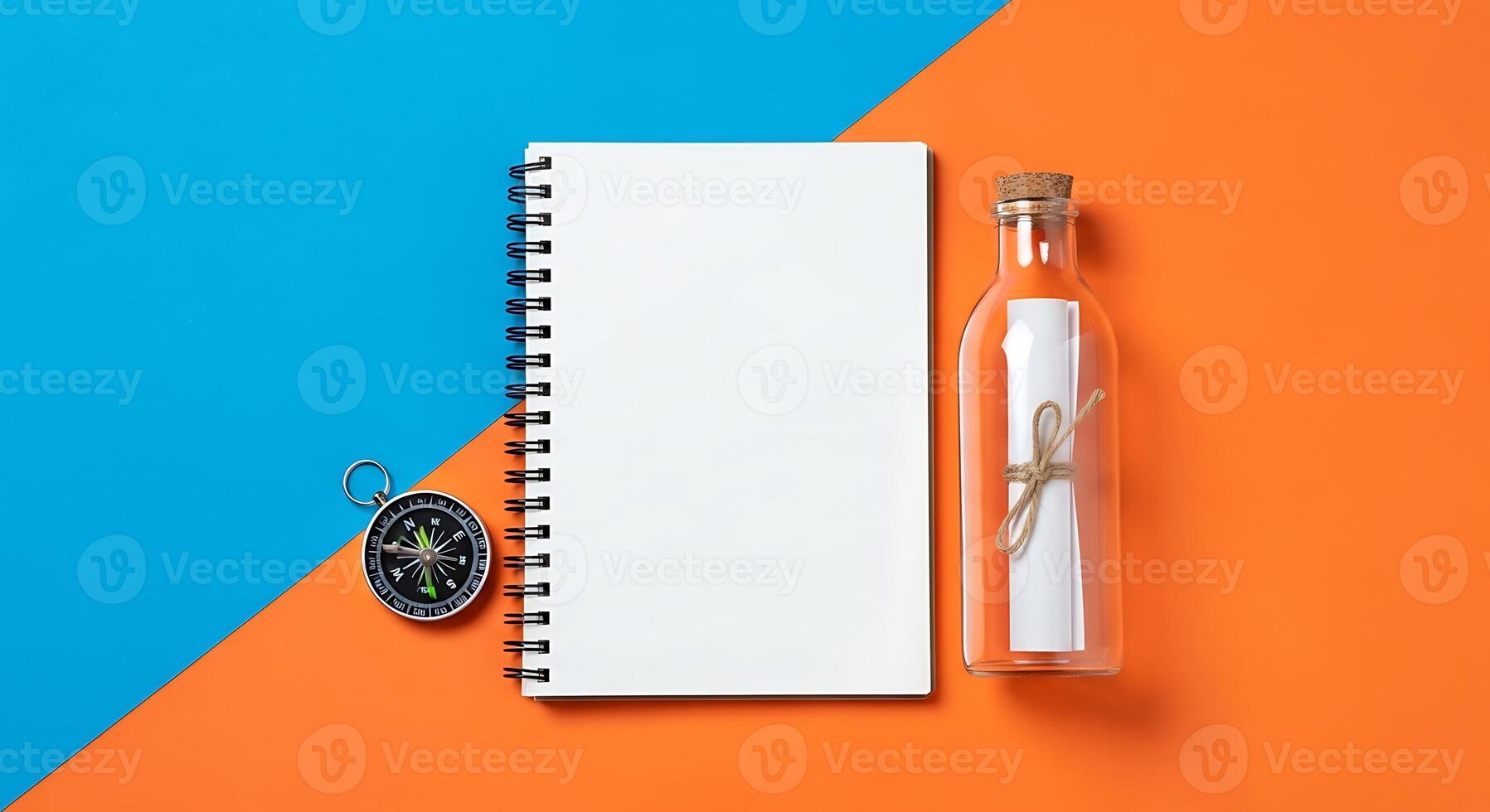 Blank Spiral Notebook Compass Message in a Bottle on Split Blue and Orange Background Space for Text Top View Flat Lay photo