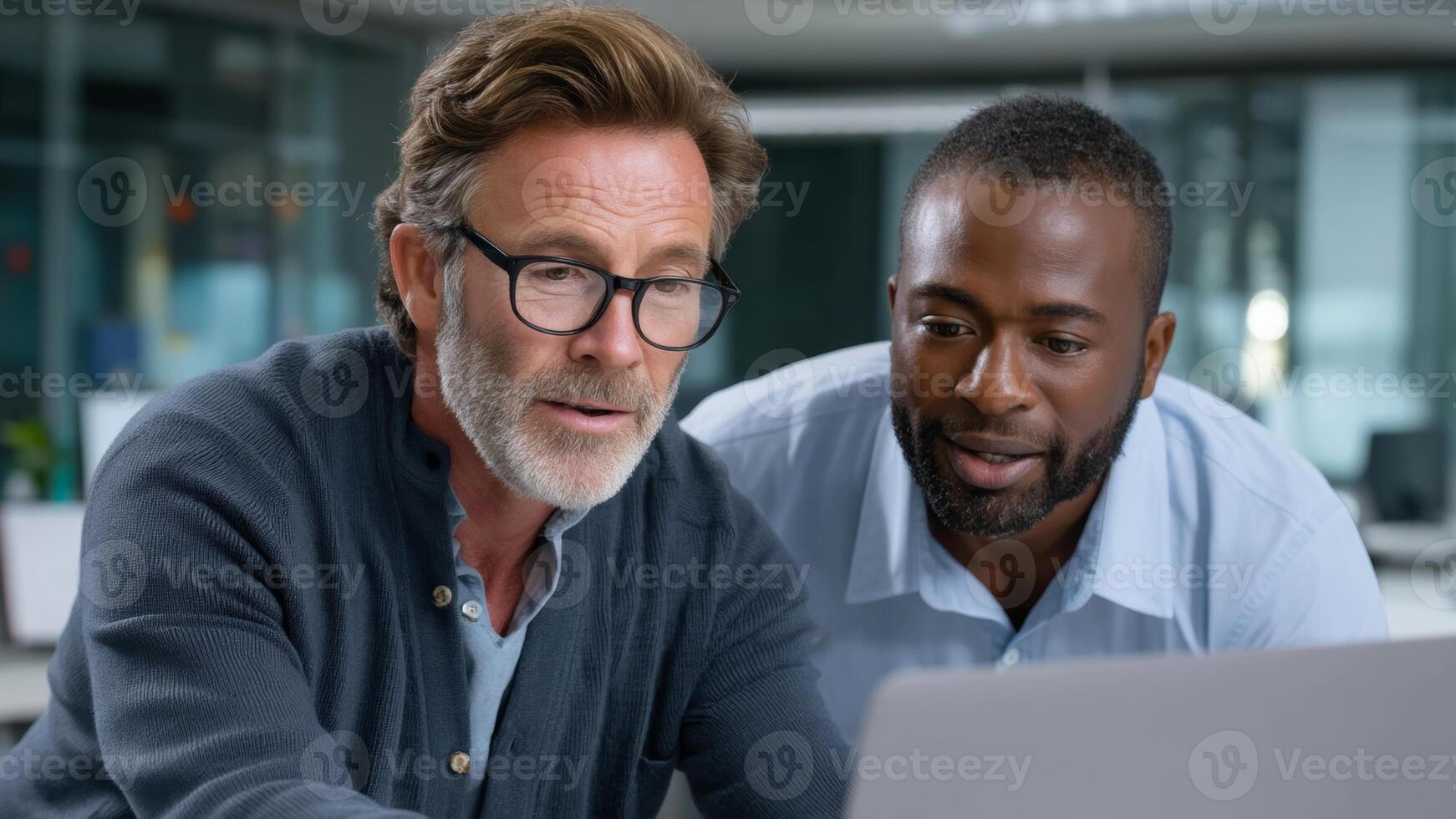 Experienced software developer mentoring colleague during training session focused on collaborative problem solving and code review photo