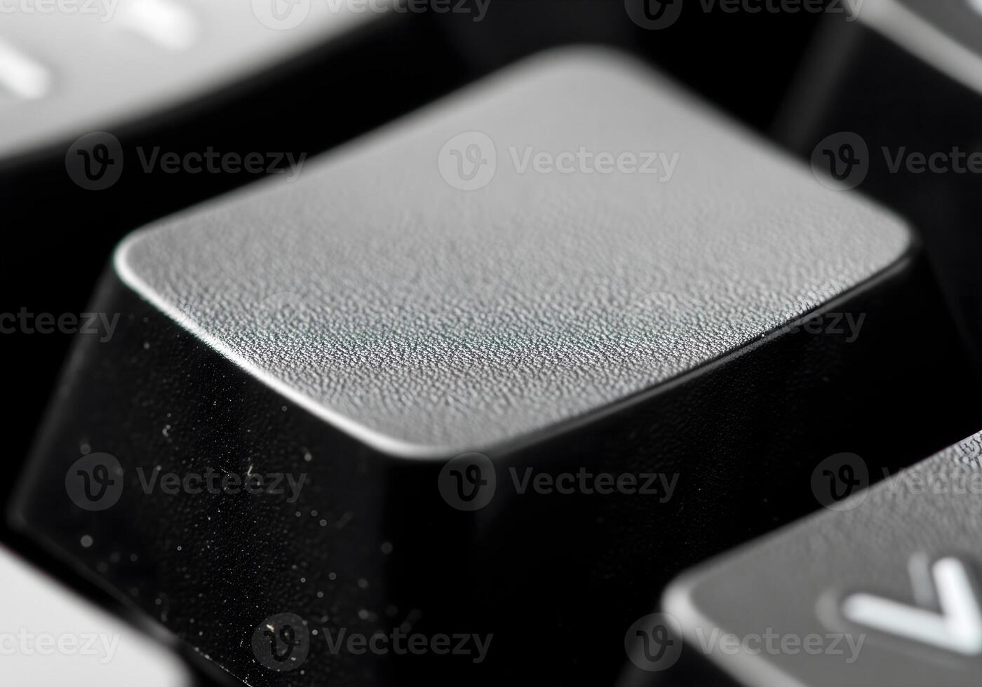 highlights a blank keycap with a slightly textured matte surface, showing fine details of its grainy finish photo