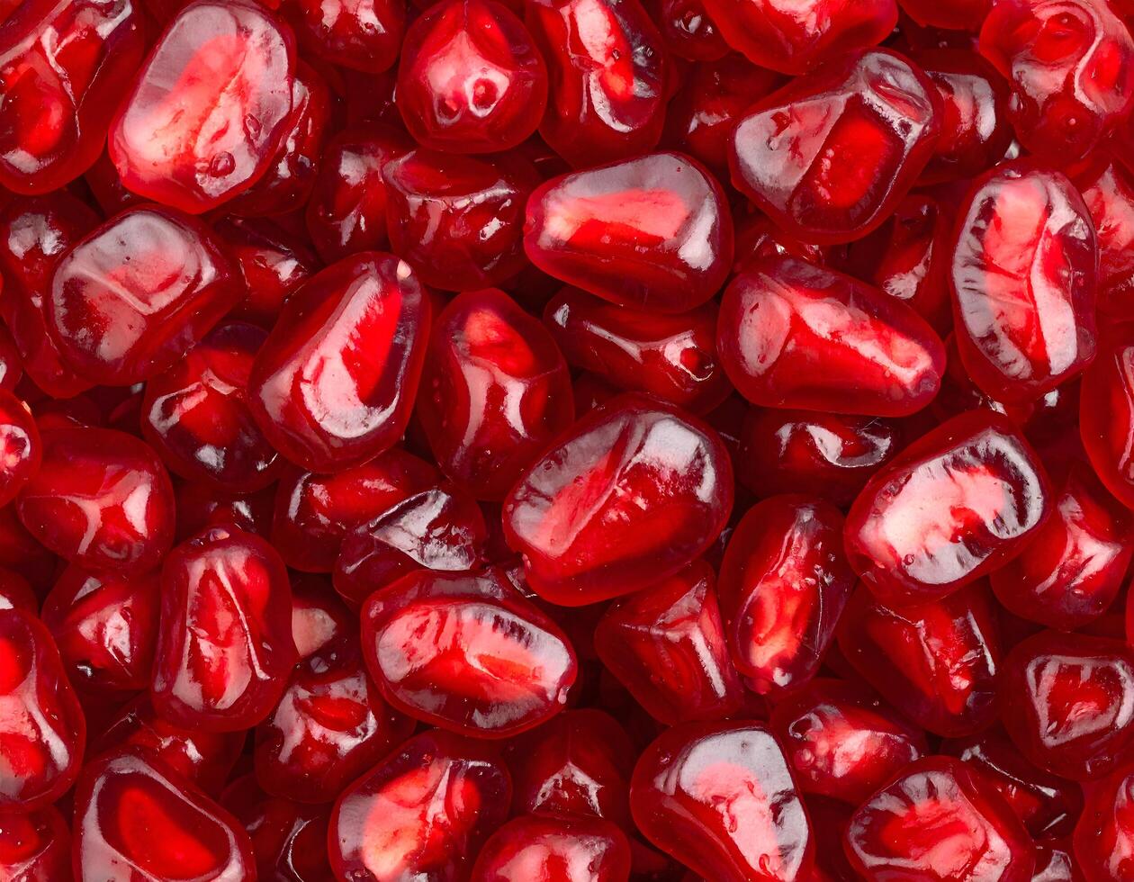 Fresh pomegranate seeds arils background texture with ruby red color photo