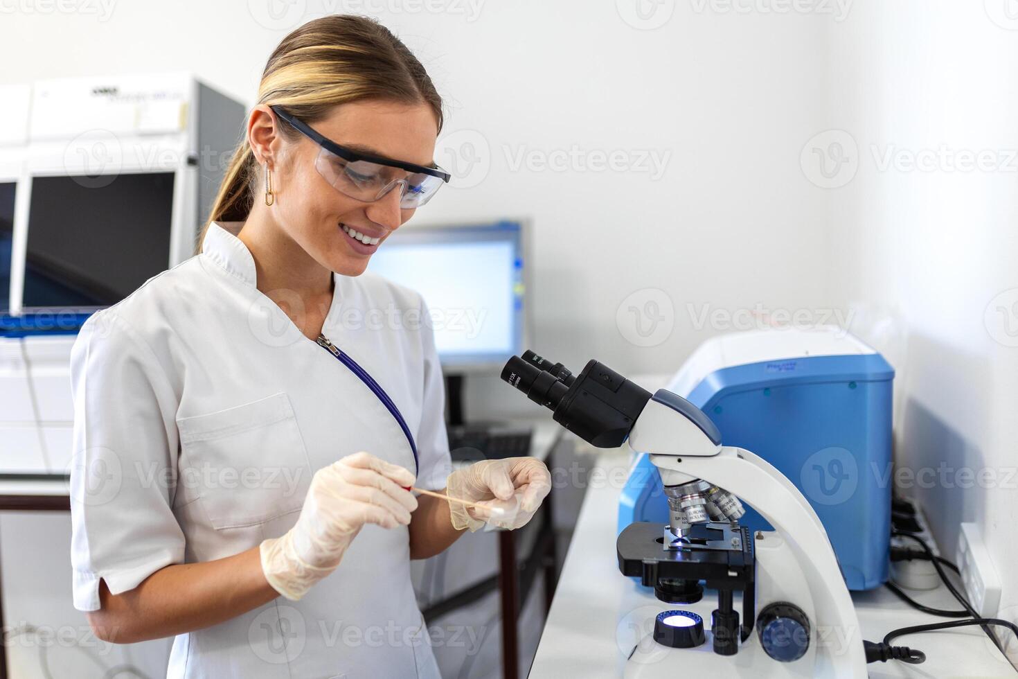 Woman biologist using micro pipette with test tube and beaker for experiment in science laboratory. Biochemistry specialist working with lab equipment and glassware for development.. photo