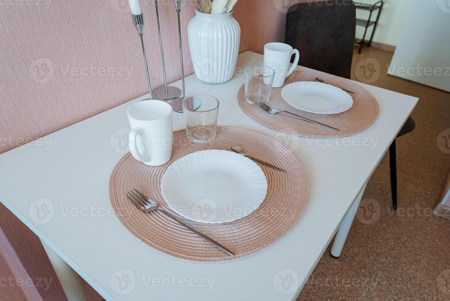 A beautifully set dining table showcasing two elegantly designed plates alongside assorted utensils, blending both style and functionality to create a truly delightful dining experience photo