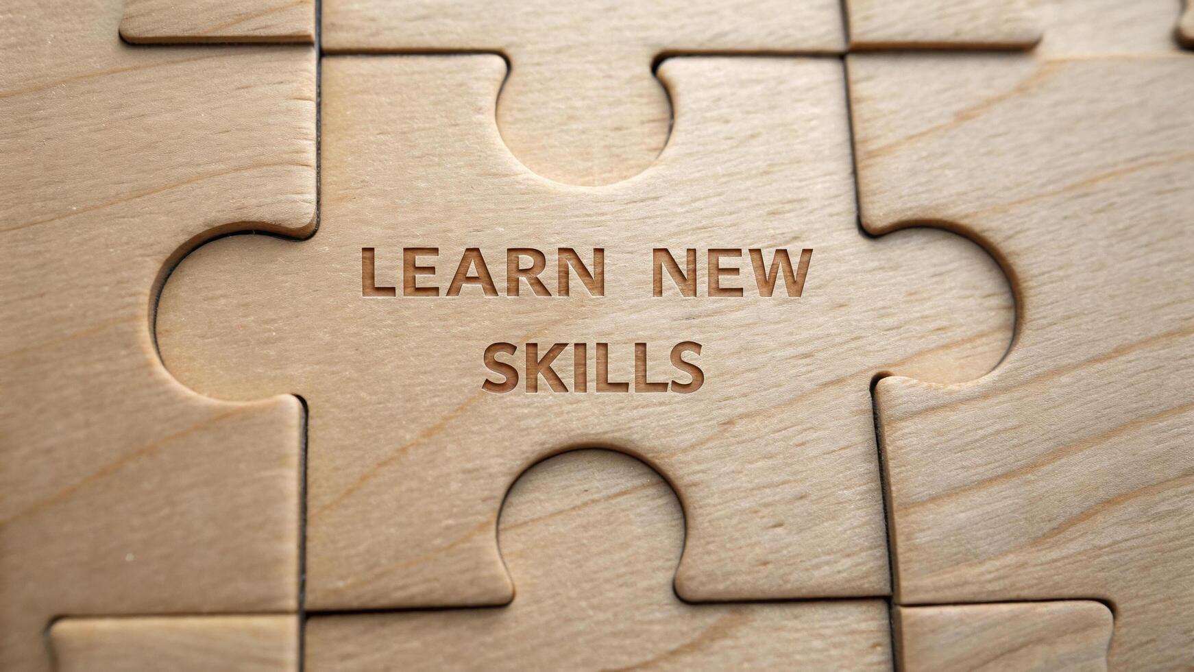 Learn new skills engraved on wooden puzzle piece symbolizes personal growth and education. This close up image highlights importance of continuous learning and development photo