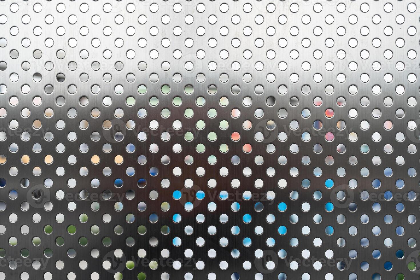 Silver Perforated Metal Sheet Background. a versatile and visually interesting texture for various design projects, from industrial and technology themes to abstract and modern concepts. photo