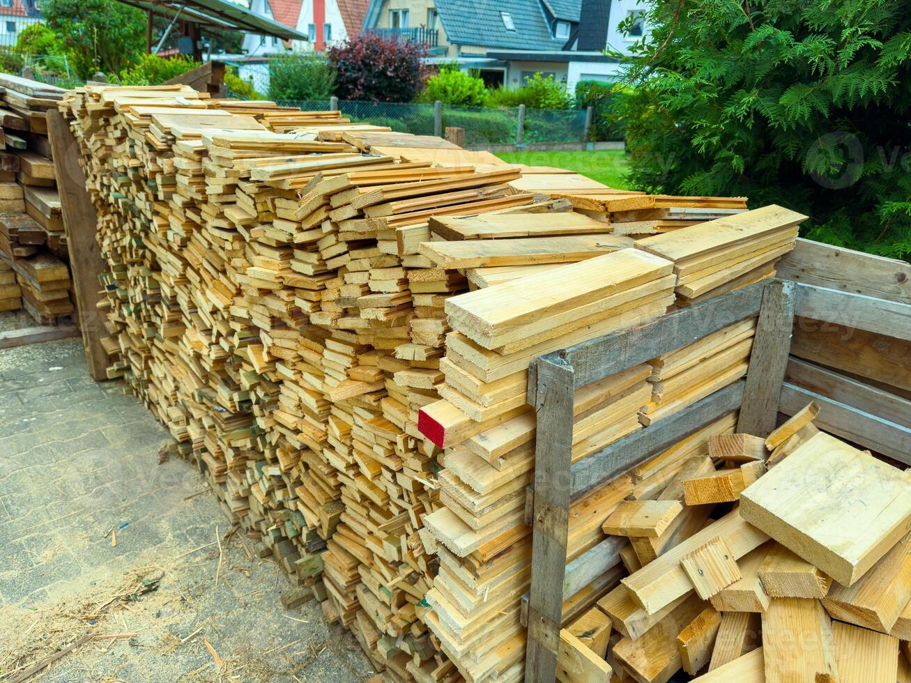 This article discusses the essential stacked timber and lumber materials that are ready to be utilized for construction or various DIY projects specifically designed for a beautiful garden setting photo