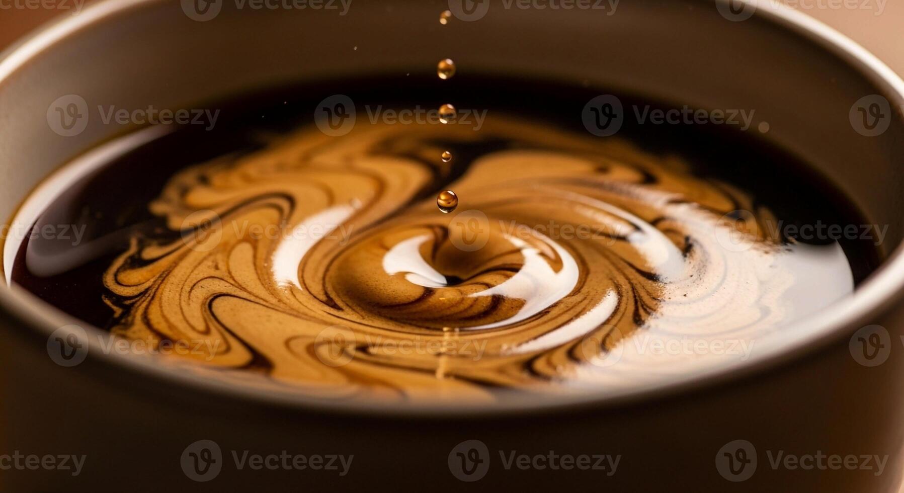 Close up of cream swirling into dark coffee creating a mesmerizing vortex pattern in a mug photo