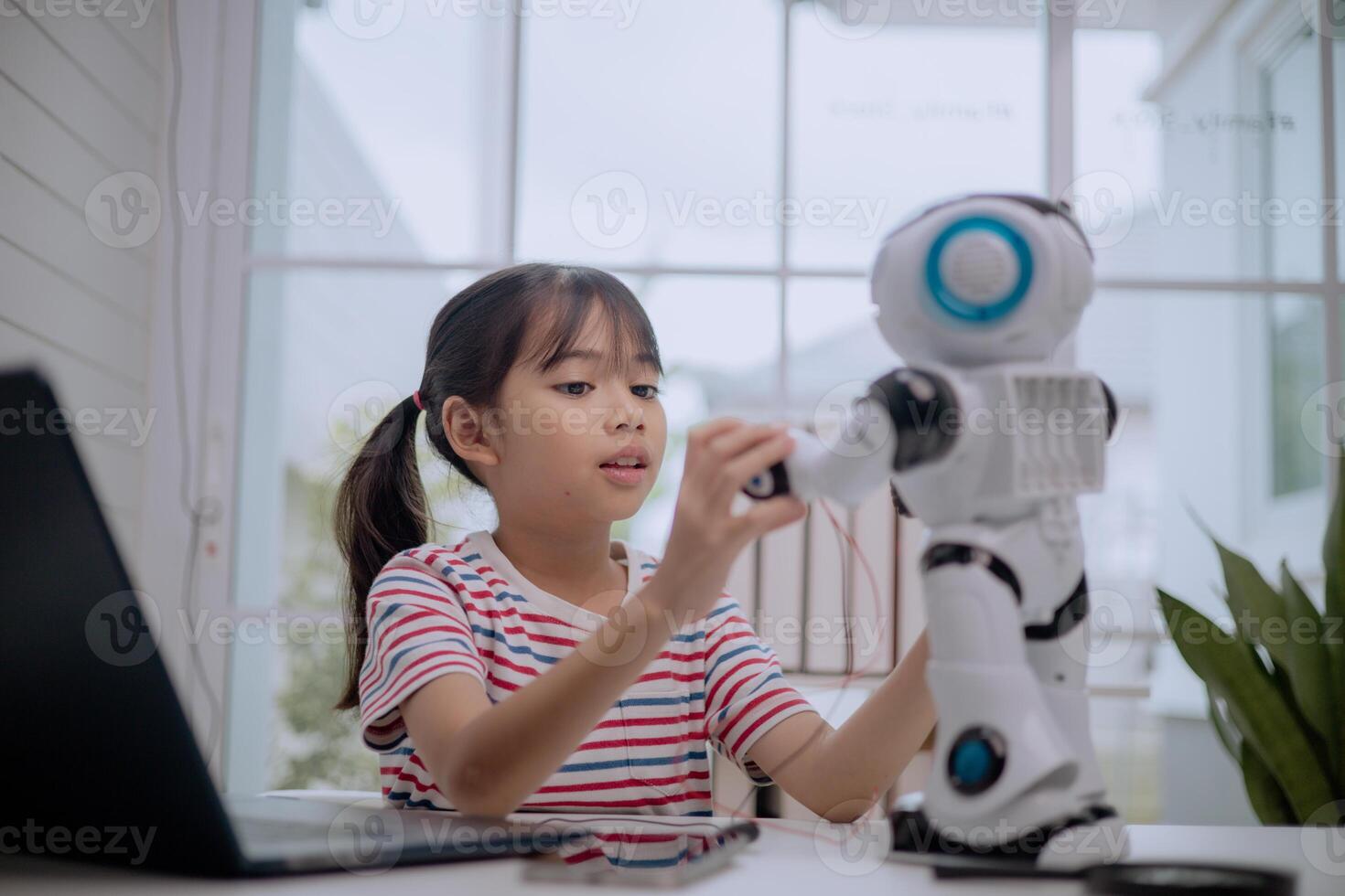 Asian girl interacting with humanoid robot at home, learning STEM education and robotics technology. Concept of child creativity, coding, artificial intelligence and future digital learning. photo