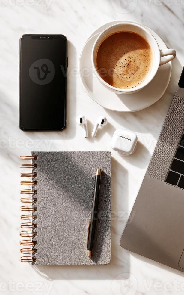 Flat lay of a minimalist desk setup with technology and coffee photo