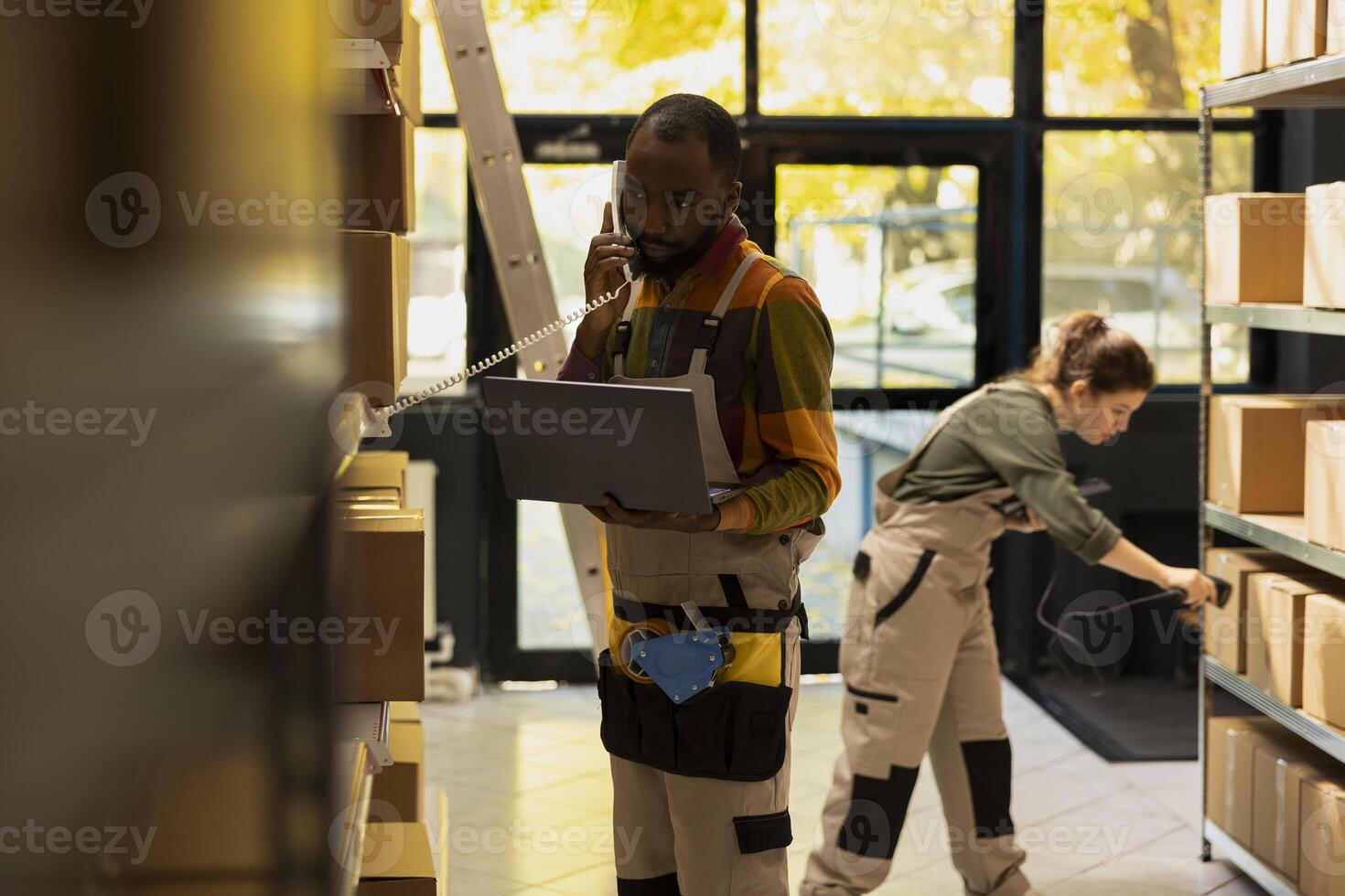 African american man in a dispatch phone conversation handles custom orders and shipping details, ensuring accurate logistics for express delivery, e-business operations and product handling. photo