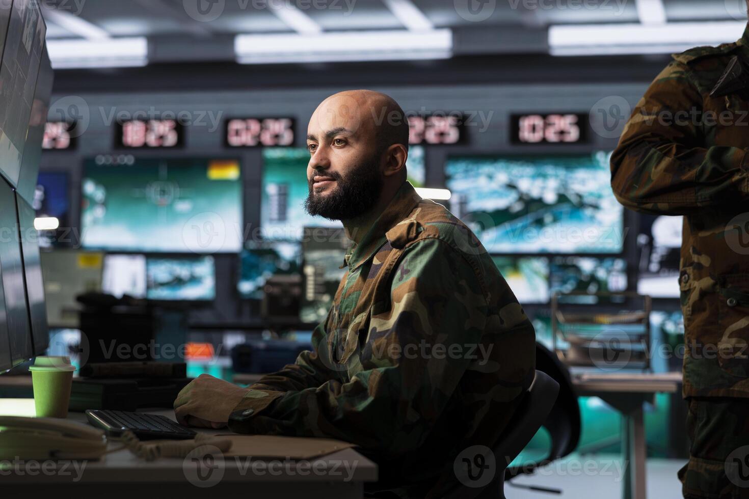 Counterterrorism division officer in war room using target acquisition tech to detect enemy location. Defense security specialist using satellite infrastructure to track threats photo