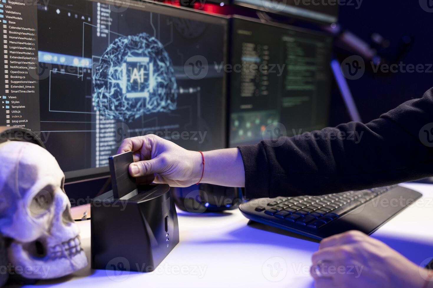 Close up of hacker uploading stolen data on SSD after using AI to break into computer systems. Rogue programmer holding hard drive with sensitive information after attack on company networks photo