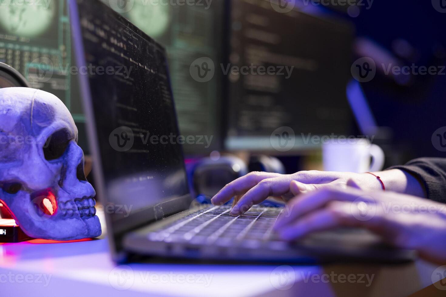 Close up of hacker using laptop to bypass firewalls during covert operations, launching DDoS attacks. Evil man typing on notebook keyboard, e working on virus scripts that can crash businesses servers photo