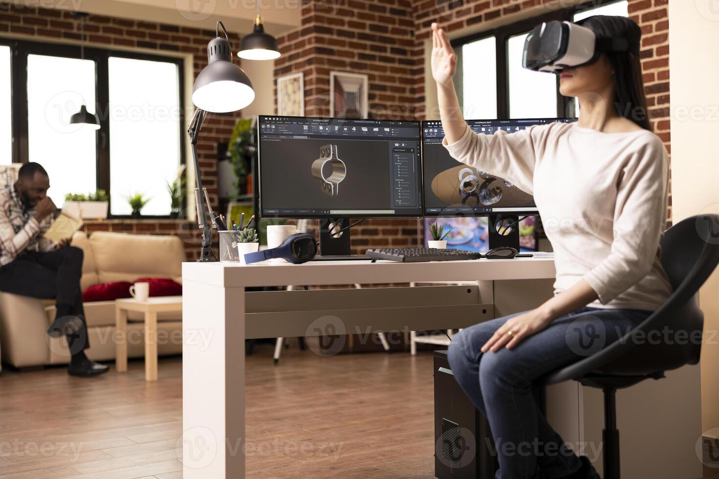 Female developer using VR headset and making hand gestures while designing clamp with CAD software. Immersive virtual reality enhances precision in computer aided design and product development. photo