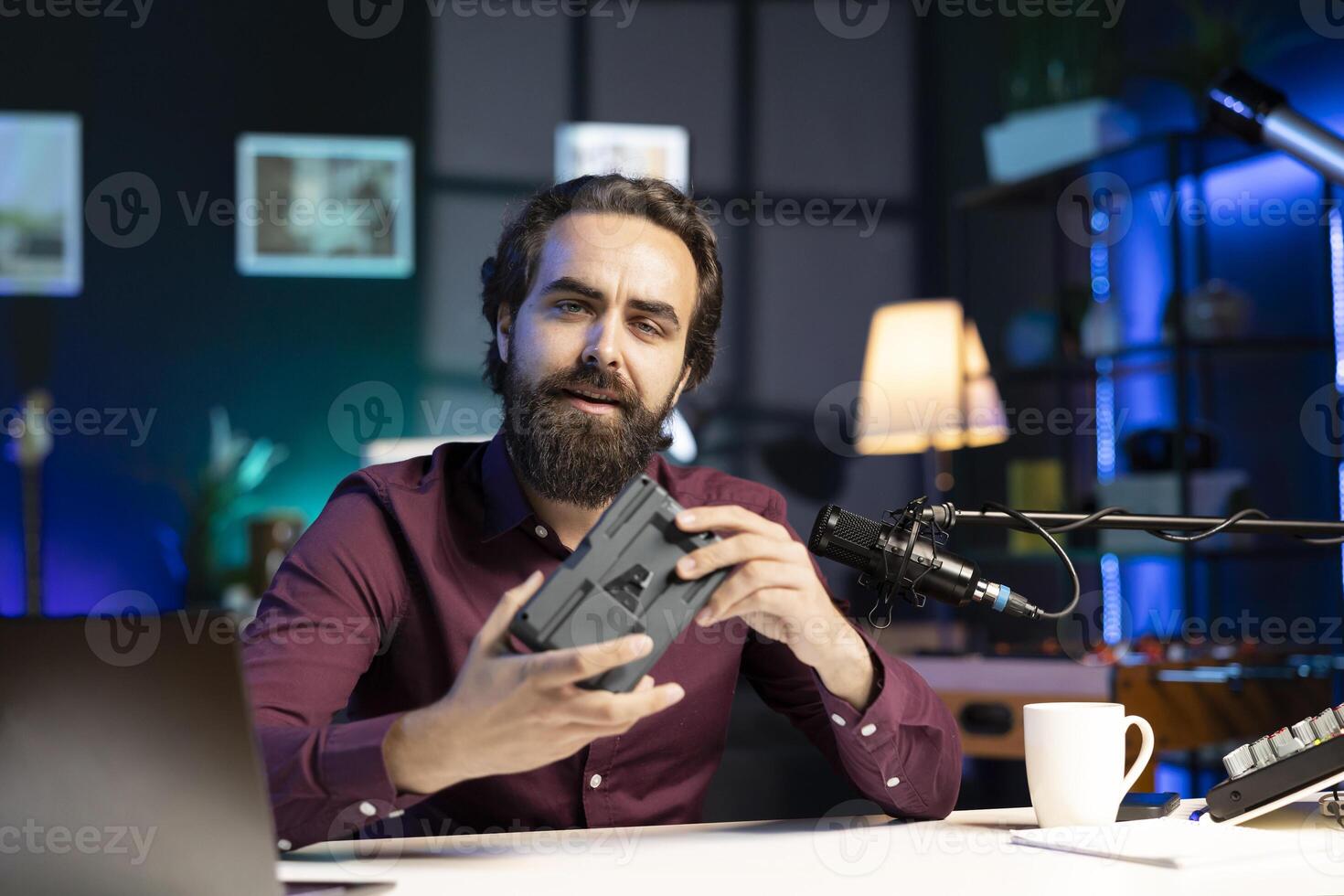 Tech content creator filming technology review of newly released V mount battery, unhappy with its performance. Media star dissatisfied with charging device, giving it low rating photo