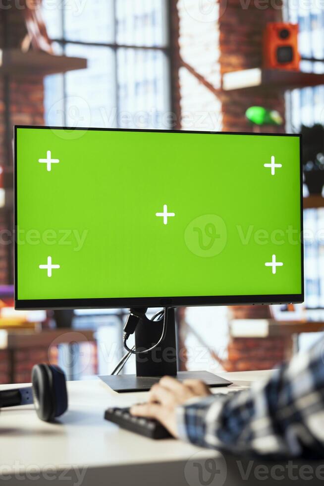 Employee in home office editing documents on chroma key computer, updating reports and files, typing. Close up of man managing digital paperwork within file directories on isolated screen PC display photo