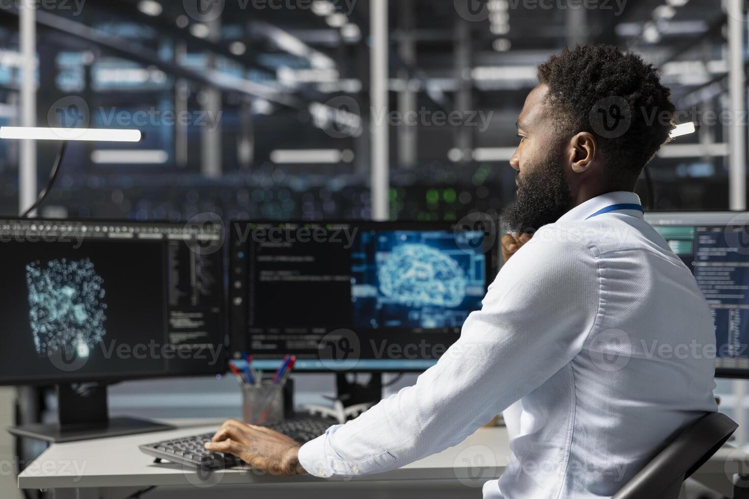 Server room worker using AI powered data visualization to perform demanding computing tasks. Admin in data center uses artificial intelligence predictive analytics for machine learning workloads photo
