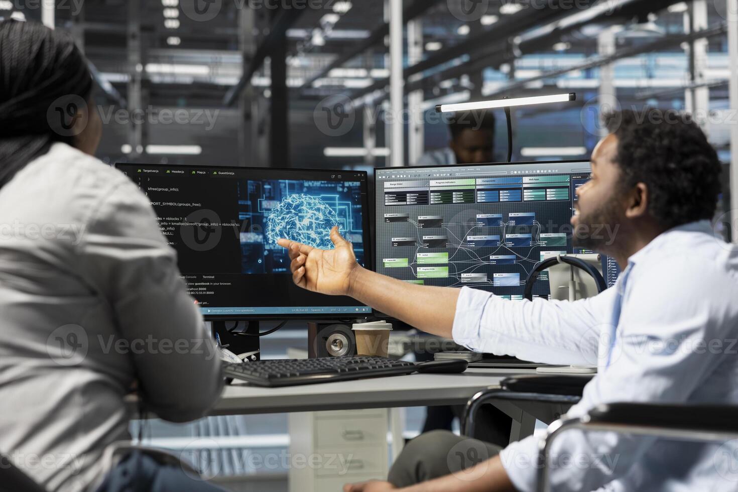 Data center manager and engineer with paraplegia using artificial intelligence computerized model. Server room team leader and worker in wheelchair using machine learning AI algorithms photo