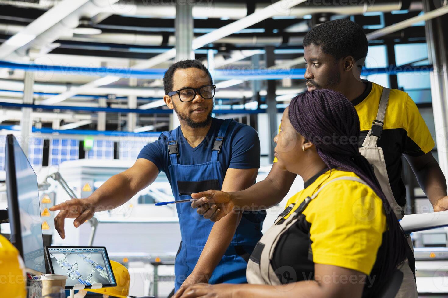 African american team of technicians doing quality control on pc, troubleshooting and fixing technical issues for solar panel production at high tech factory. Coworkers inspecting system. photo