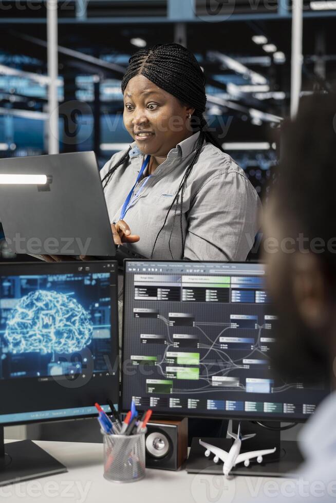 Admin in data center using artificial intelligence computerized model floored by impressive results. Server room employee working with AI machine learning algorithms positively surprised by efficiency photo