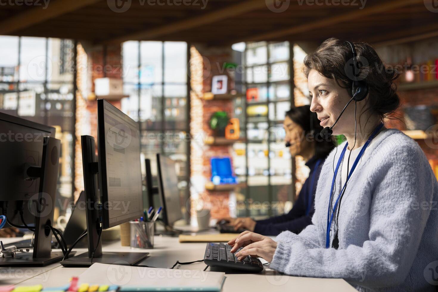 Call center agent analyzing customer feedback data, working to reduce complaints. Customer service employee using problem solving skills to address customer needs effectively photo