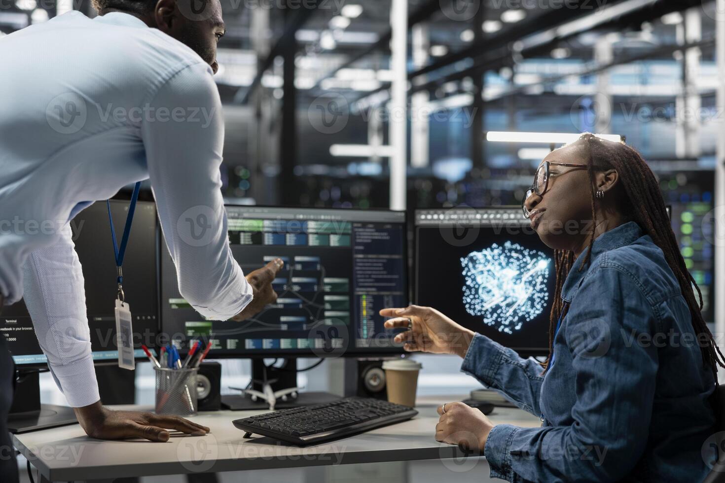 Data center engineers brainstorming, using AI visualization tool to improve resource allocation. Server hub coworkers working together to do artificial intelligence predictive analysis photo