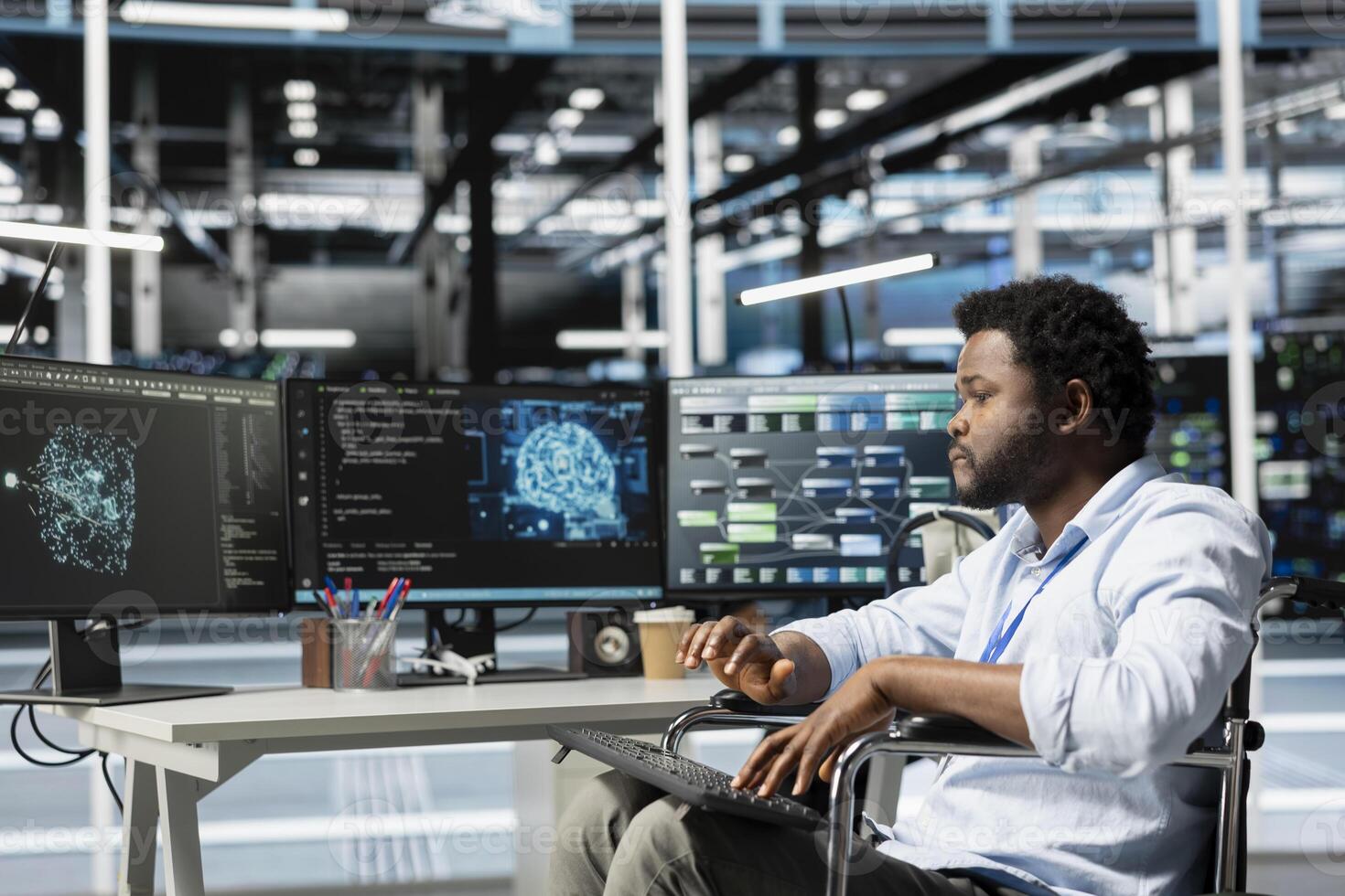 Data center engineer with disability in wheelchair using AI visualization tool. Worker with paraplegia in inclusive server farm workplace uses artificial intelligence analysis software photo