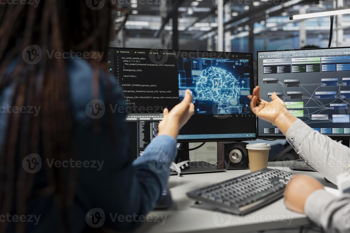 Data center engineer and colleague use artificial intelligence neural networks technology. Teamworking employees doing brainstorming in server room, using AI programming language to configure hardware photo