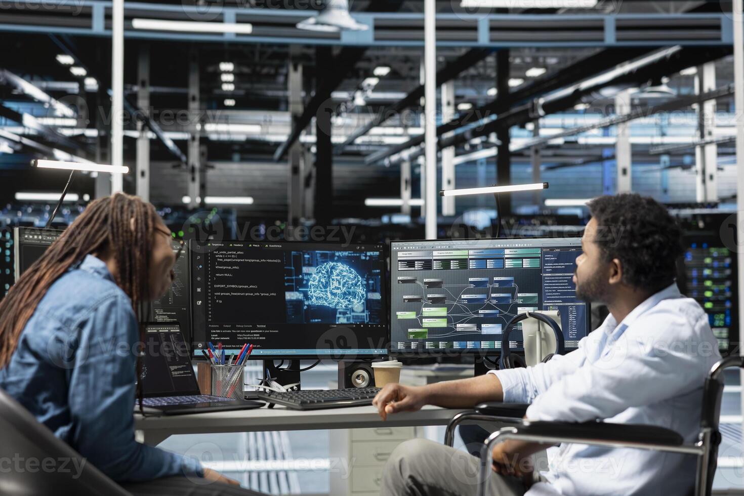 Engineer with paraplegia and coworker setting up data center equipment needed to run artificial intelligence and machine learning. Server room worker with disability and colleague using AI tools photo