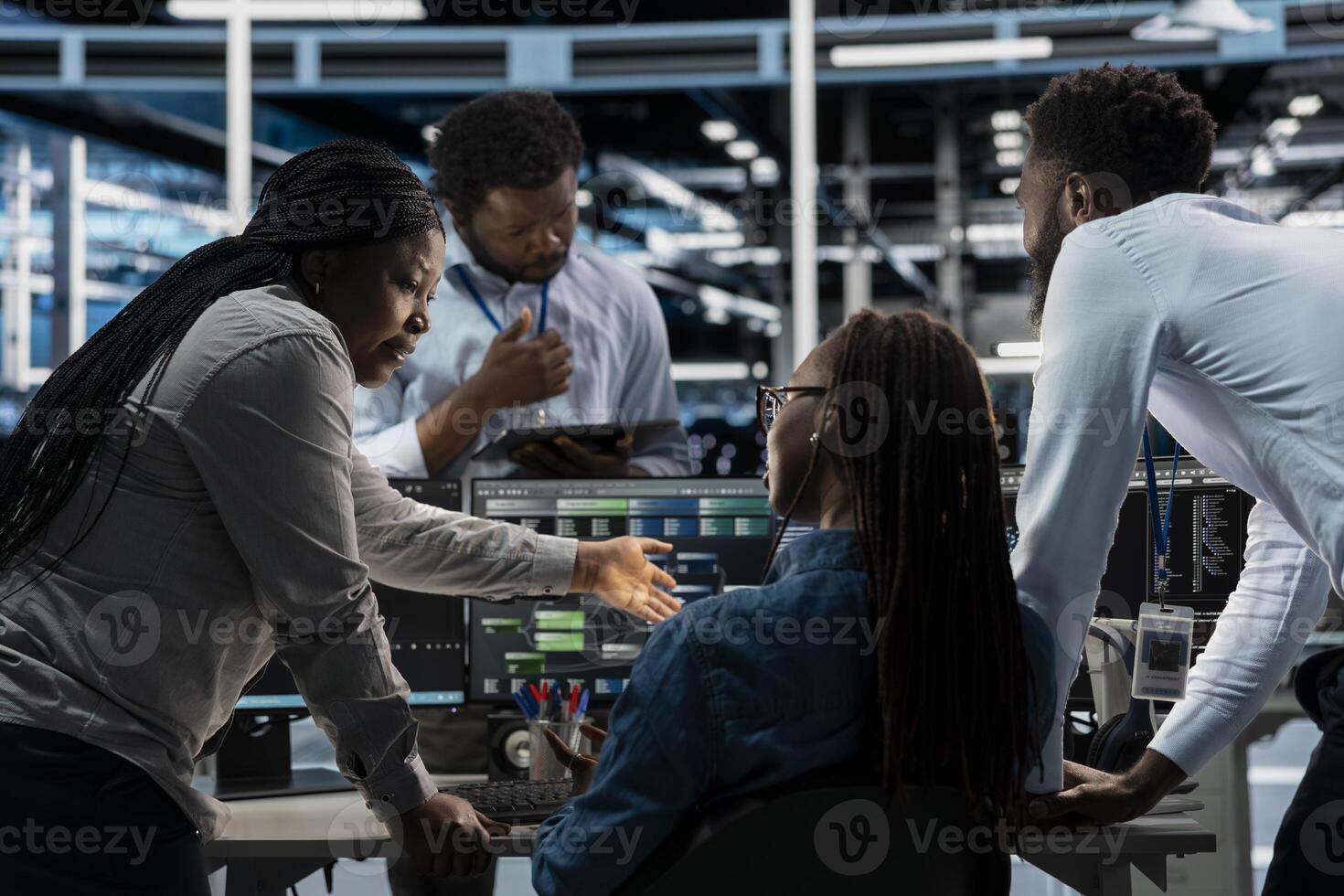 Data center coworkers doing brainstorming, programming equipment used for machine learning training. Teamworking server farm colleagues running code on PC to upgrade artificial intelligence systems photo